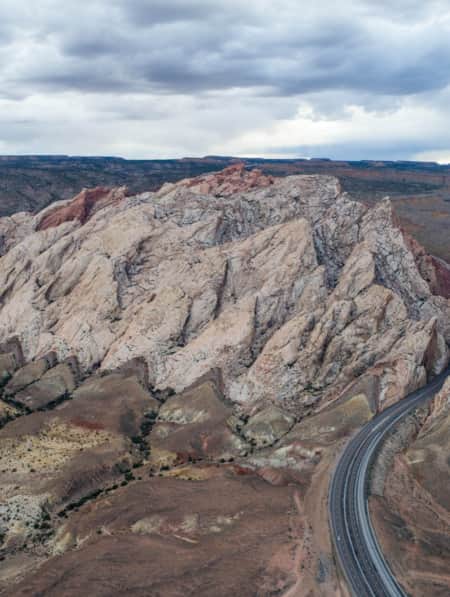 A road cutting through large rock formations.