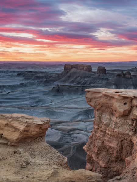 A desert landscape featuring rock plateaus.