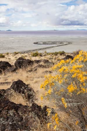 A view of a jetty extending from the shore into a lake.