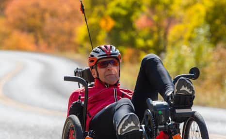 Bob Wassom cycling Cache Valley in the fall on a recumbent e-trike.