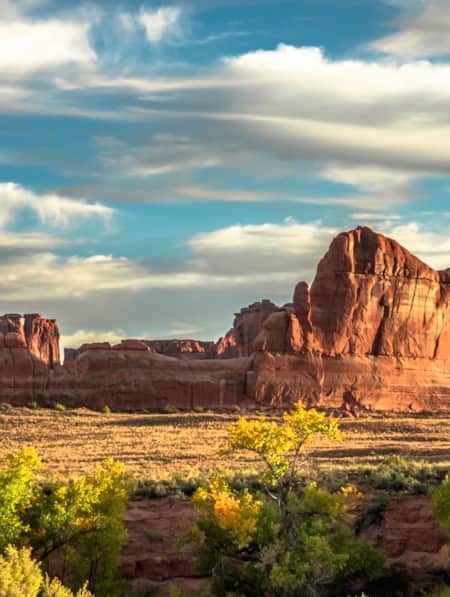 Sunlight illuminating the features of the red rock at Courthouse Wash in Arches National Park.