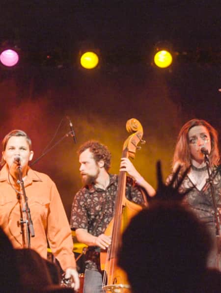 Four members of a band preforming on stage.