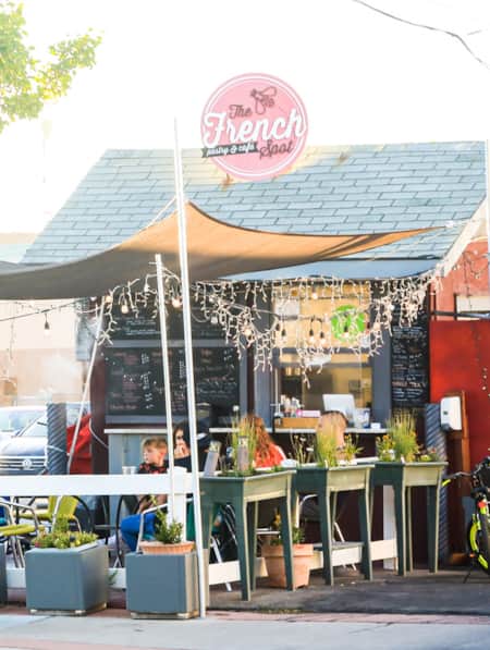 People dining on the patio in front of a restaurant.