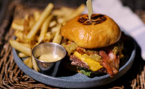 The Urban Hill smash burger features smoked bacon and hatch chile.